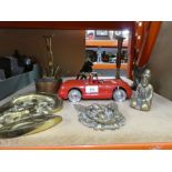 A selection of brass and copper ware including candlesticks, brass door knocker and a model red car