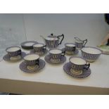 A Royal Doulton Art Deco style tea set for six, having purple - striped decorations, by Robert Alan