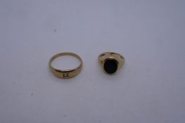 9ct yellow gold gypsy ring set with a single clear stone, and a 9ct yellow gold signet ring with bla