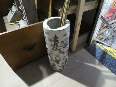 An oriental style stick stand with contents