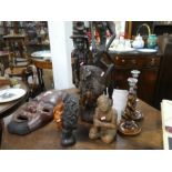A quantity of African hardwood carvings, other carvings and a pair of Barley twist candlesticks