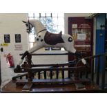 A Victorian painted rocking horse having leather saddle on pine base, 145cm long