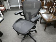 A Herman Miller, a modern Aeron desk chair on revolving base.