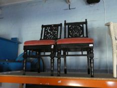 A pair of early 20th century ebonized chairs