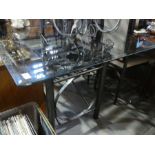 A modern glass oblong kitchen table on iron tubular base and a set of 6 chairs, wine rack,