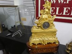 An antique French Ormolu mantle clock of lady seated on a boat. inlaid wooden musical box base, dome