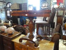 An antique rosewood foldover card table on turned pillar