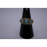 Pretty 18ct yellow gold ring set with 3 opals with green and red flashes, separated by 4 diamond chi