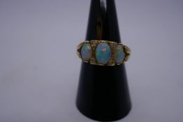 Pretty 18ct yellow gold ring set with 3 opals with green and red flashes, separated by 4 diamond chi