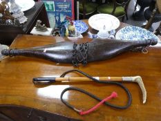 An old horse riding whip by Andres of Oxford and an old Yoke with chains