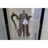 A silver Victorian coffee pot in a raised foot with ebonised wood handle. Hallmarked Sheffield 1899,