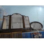 An old mahogany triple dressing mirror and an oval wall mirror