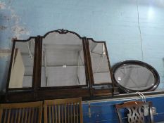 An old mahogany triple dressing mirror and an oval wall mirror