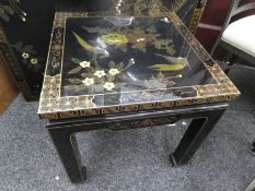 Black laquered oriental design square table, decorated with birds and flowers and matching coffee ta