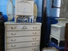 A cream painted chest having five long drawers, a triple mirror and matching beside table