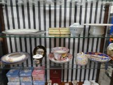 Two shelves of china including Poole items and a Vienna porcelain cup and saucer, and a tin of cigar