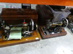 Two vintage hand cranked Sewing machines, one a Vickers the other a Singer