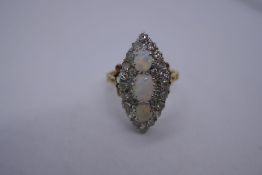 Antique yellow metal dress ring with three oval white opals with blue and green flashes, one A