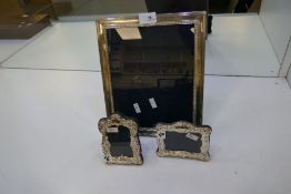 Three silver photoframes to include two small ornate frames,14cm x 9cm approx and 11cm x 12cm approx