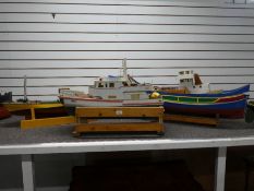 Three remote controlled wooden boats all with some workings, the largest 100cm