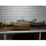 Three remote controlled wooden boats all with some workings, the largest 100cm