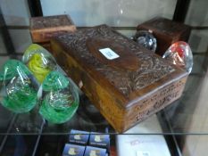 Selection of glass paperweights and three carved camphor wood boxes.