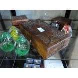 Selection of glass paperweights and three carved camphor wood boxes.