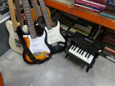 A large selection of various guitars, electric and accoustic and a small piano