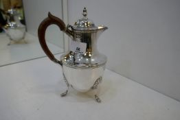 A silver Victorian small hot water jug on three pretty feet and wooden handle. Nice handle. Hallmark
