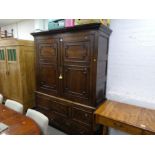 An antique bacon cupboard having panelled doors with 2 drawers to base, 155cm