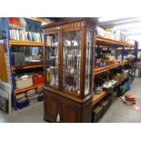 A reproduction mahogany bookcase having pair of glazed doors with cupboard below