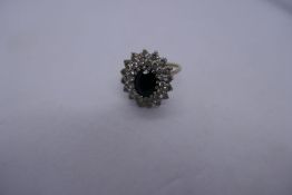 9ct yellow gold cluster ring with central sapphire surrounded white stones, marked 375, Size O, appr