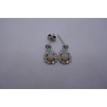 Pair of white gold drop earrings, with central pear shaped opals, with blue and green colour flashes