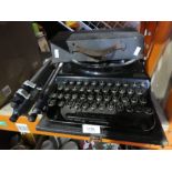 Remington home portable type writer and tripod.