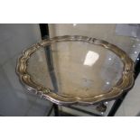 A large circular silver tray on four feet, with engraved message underneath hallmarked Sheffield 191