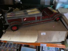 An old Meccano model car and a box of Meccano including paperwork