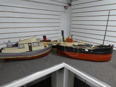 Three remote controlled wooden boats, containing some workings