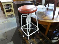 A vintage adjustable stool with sprung movement