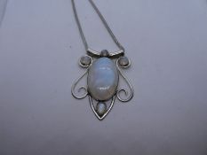 Contemporary silver necklace hung with a large silver pendant inset with moonstone