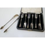 A silver pair of tongs hallmarked Dublin 1813, Samuel Neville. With a cased set of 6 silver cake for