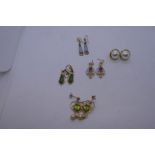 Pair of 9ct gold heart shaped drop earrings each set with peridot and hung with a pear, yellow metal