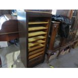 An oak tambour filing cabinet