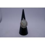18ct white gold cluster ring, with central oval with opal approx 1cm, length 0.05 to 0.10 cara