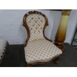 A Victorian button back nursing chair having carved wood frame.