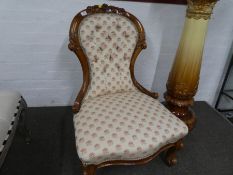 A Victorian button back nursing chair having carved wood frame.