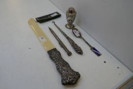 A silver lot comprising of a silver pen, handled ornate button hook, a white metal rim sovereign cas