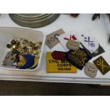A small quantity of military badges, buttons and similar