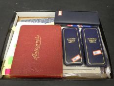 Four autograph albums containing signatures including Petula Clark and Anne Crawford. Three medals