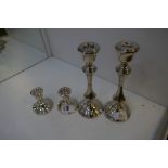 Two pairs of silver candlesticks, small pair hallmarked Birmingham 1968 JP. 8cm high approx. Larger