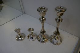 Two pairs of silver candlesticks, small pair hallmarked Birmingham 1968 JP. 8cm high approx. Larger